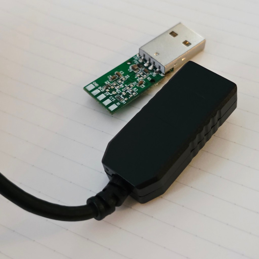 A USB connector and a printed circuit board with electronic components attached.