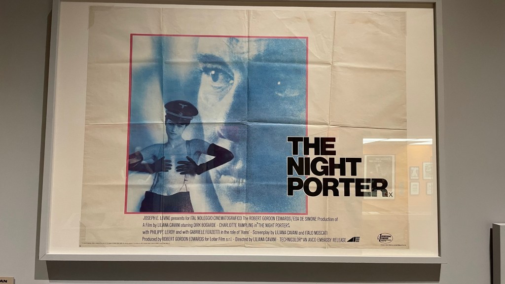 A vintage movie poster for 'The Night Porter', featuring a blue-toned image of a man and a woman. The poster includes the film's title in bold black letters, along with credits at the bottom.